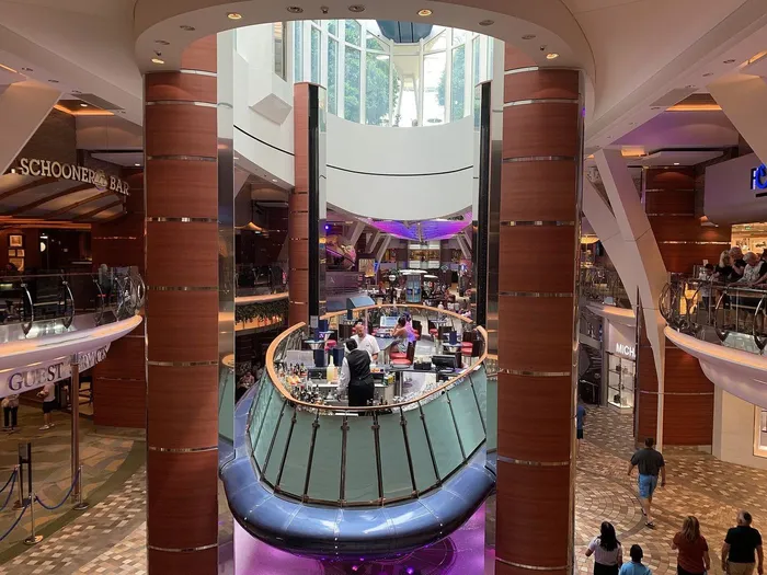 Rising Tide bar on the Royal Promenade of Oasis of the Seas, with the Guest Relations desk at left