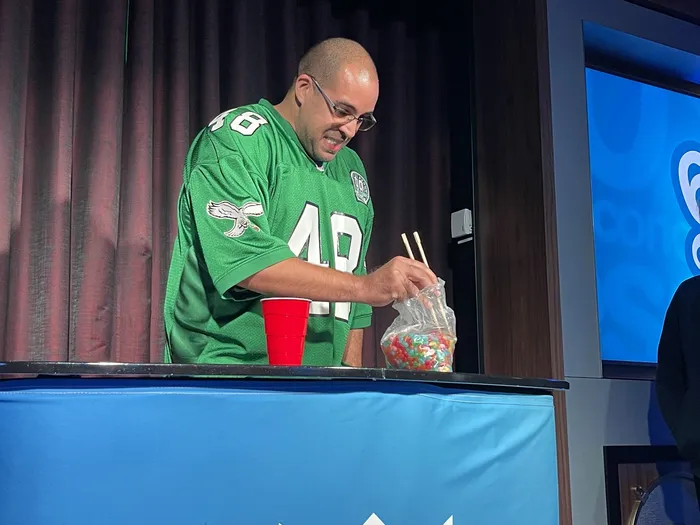 Contestants sorting jellybeans with chopsticks in the '60 Seconds or Less' challenge
