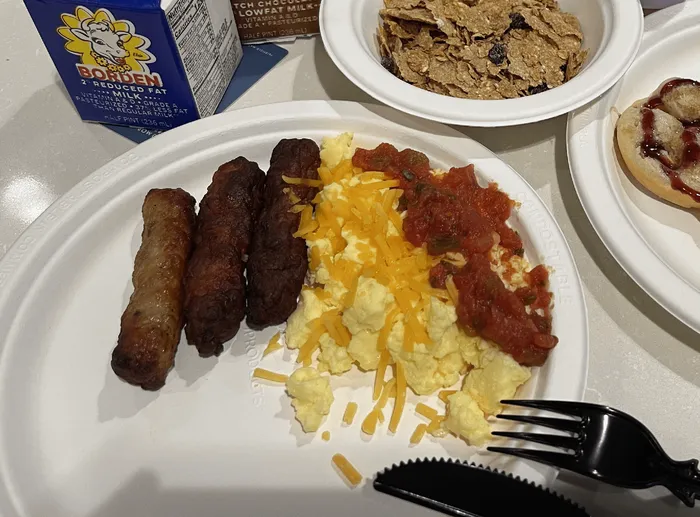 Shredded cheese bin at a hotel breakfast bar