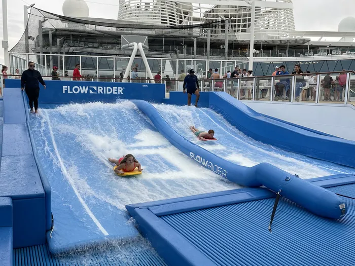 Two riders sharing the FlowRider lane during a dedicated session