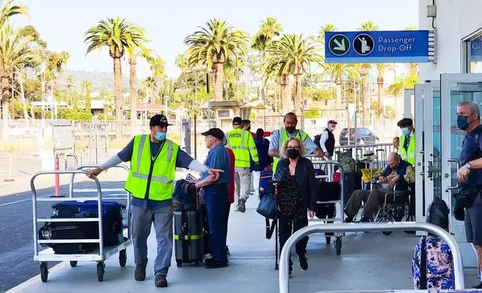 Cruise terminal porter loading bags onto a luggage cart