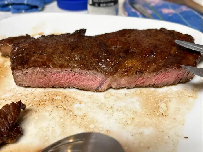 Utility grade ribeye steak after sous vide cooking and torch searing