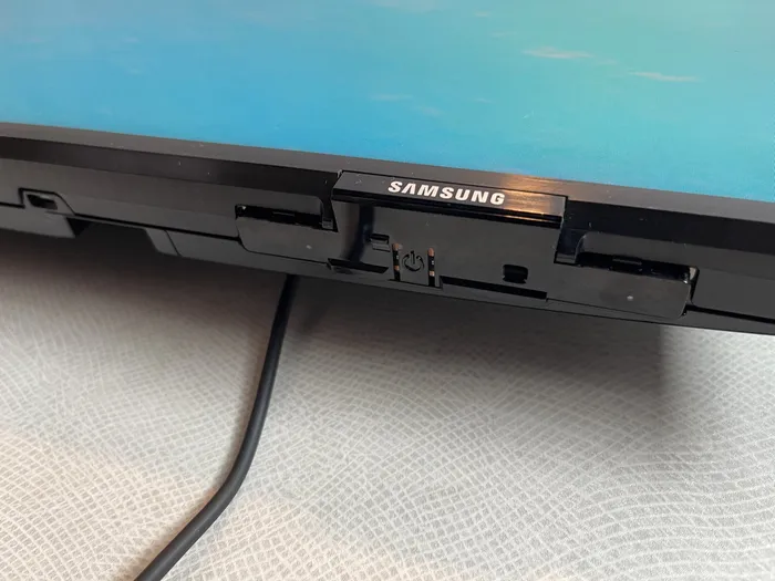 Power button located beneath the screen on a Royal Caribbean Samsung TV